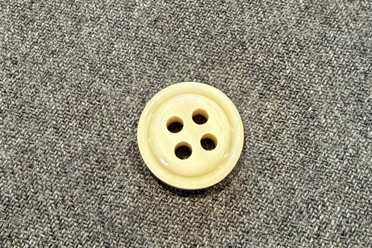 Button on a gray fabric surface