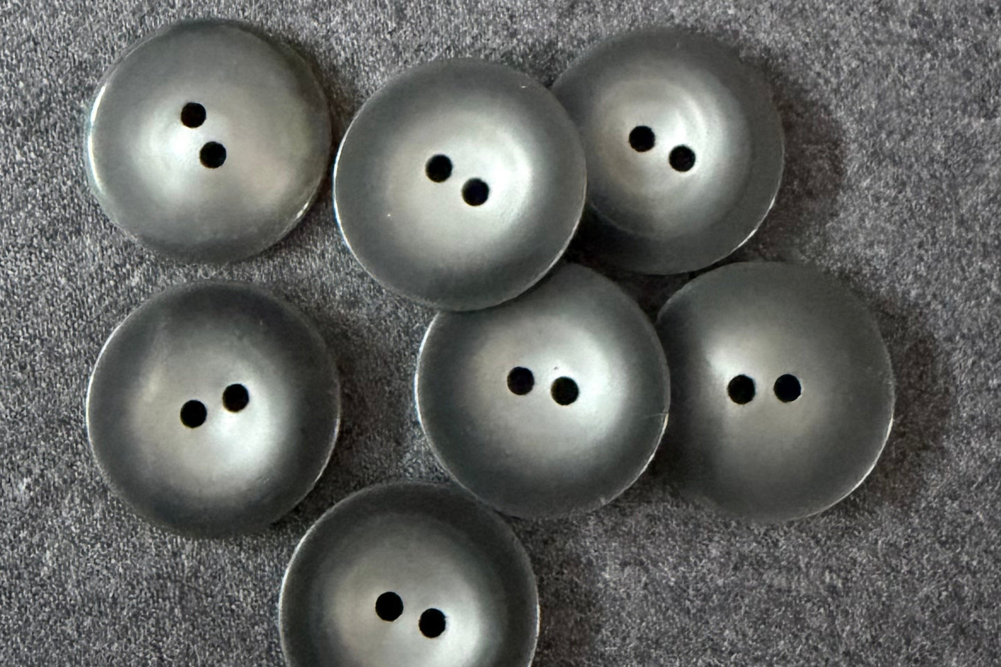 Set of grey buttons on a textured gray surface