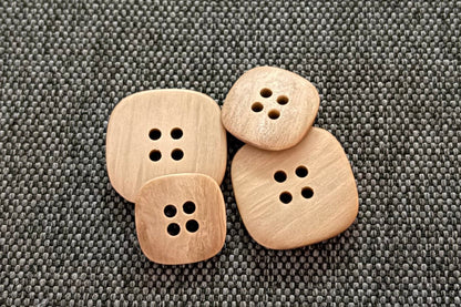 Tan buttons on a gray fabric background