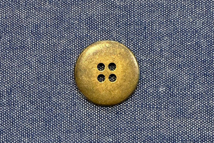 bronze button on blue fabric