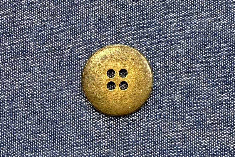 bronze button on blue fabric