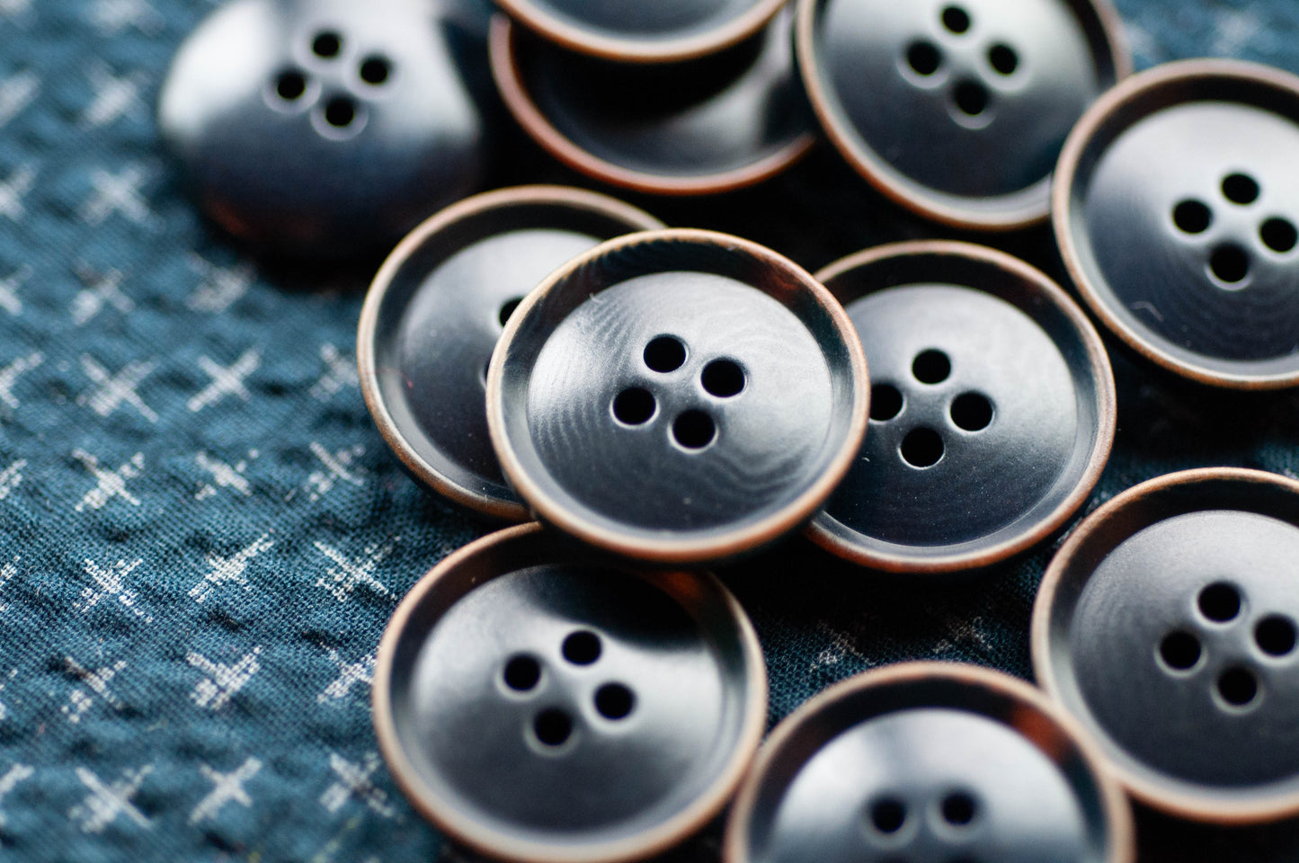 Close-up of blue buttons on a textured fabric background